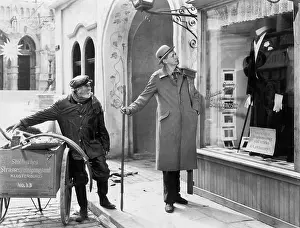 Noticing: Man looking at a window display of a tuxedo