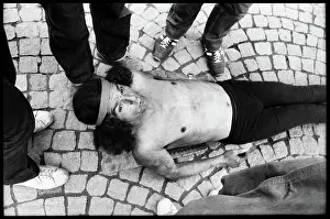 Nails: Man lying on bed of nails - street performer, Paris, France