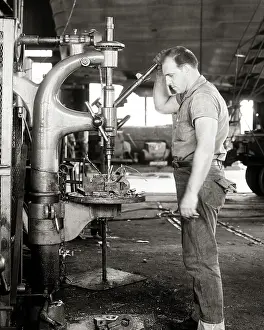 Machinist: Man Machinist Standing Working a Drill Press