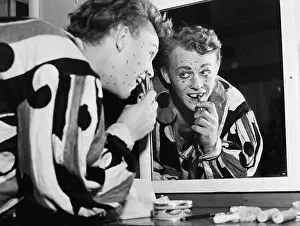 Showmanship: Man in front of a mirror putting make up on