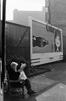 Krish: Man with newspaper near advertising hoarding