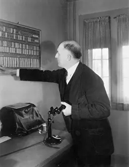 Calendars: Man in his office looking at a board