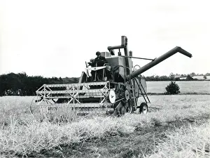 Farmhand: Man operating a combine harvester, Cornwall