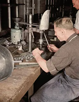 Accuracy: Man operating a drill press making vital parts
