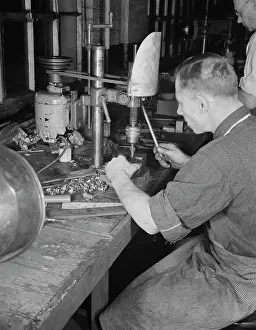 Accuracy: Man operating a drill press making vital parts