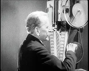 Cinematograph: Man Operating An Early Cinematograph Machine