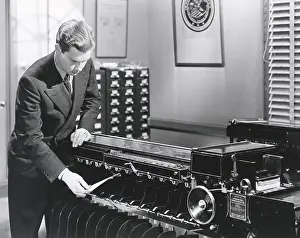 Organize: Man operating fingerprint sorting machine