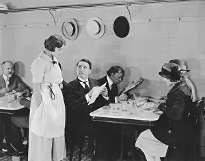 Options: Man ordering from menu in restaurant