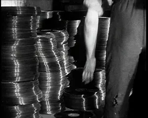 Vinyls: A Man Organizing Vinyls to Use For War Materials
