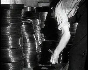 Vinyls: A Man Organizing Vinyls to Use For War Materials