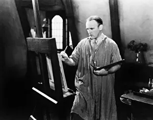 Ingenuity: Man painting on an easel with a paintbrush
