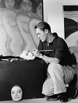 Focused: Man painting masks