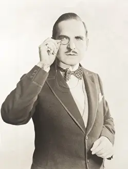 Doubtful: Man peering through monocle