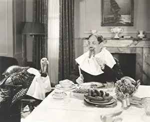 Napkin: Man and his pet turkey sitting down to an untraditonal