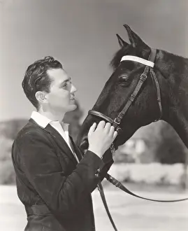 Stroking: A man petting his horse