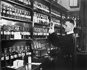 Blend: Man in a pharmacy mixing medicine