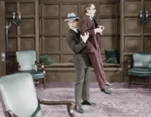 Fedora: Man picking up frightened man