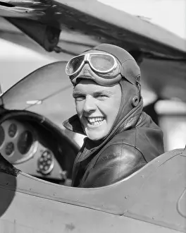 Adventuresome: Man Pilot Sitting in Open Air Cockpit Smiling