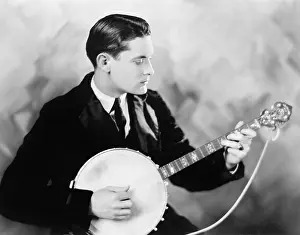 Tunes: Man playing a banjo