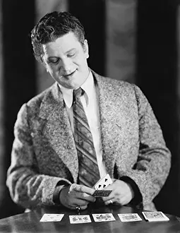 Diversions: Man playing with a deck of cards