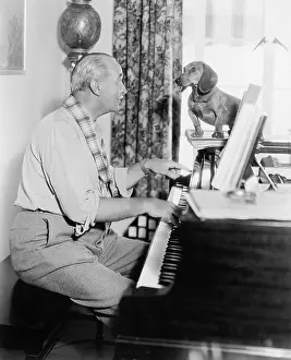 Tunes: Man playing for his dog the piano