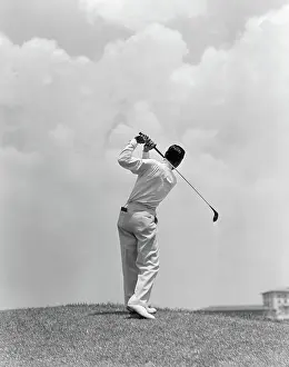 Fairway: Man playing golf teeing-off golf ball from tee