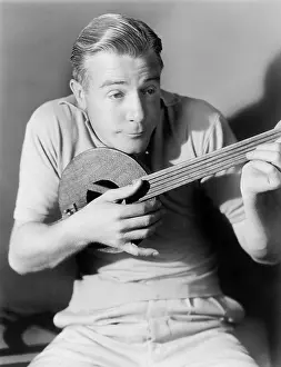 Miniatures: Man playing a lute, a small instrument