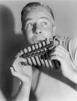 Tunes: Man playing a pan flute