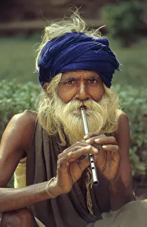 Hirsute: Man playing tin whistle, Agra, India - 1