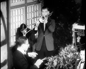Trombone: Man Playing the Trombone Next to a Jazz Band