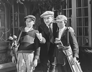 Newsboy: Man pointing out something to golf caddies