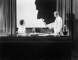 Drapes: Man pointing at a large silhouetted face