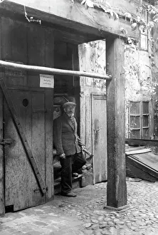 Forbidden: Man in front of a poor house in the Petristrasse