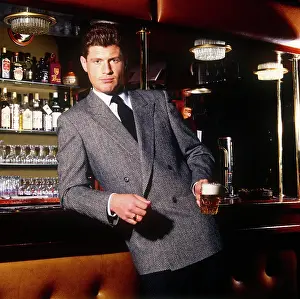 Herringbone: Man posing in a grey jacket in a bar