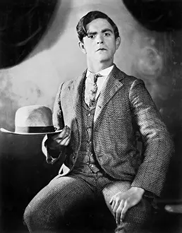 Self Satisfaction: A man posing with his hat
