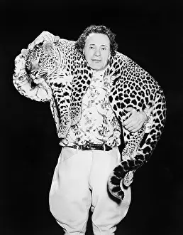 Professionals: Man posing with a leopard around his neck