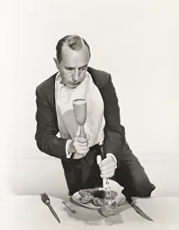Cracking: Man preparing to crack open oyster shell with mallet