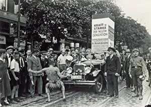 Friedrichshain: Man pulling a car with his teeth