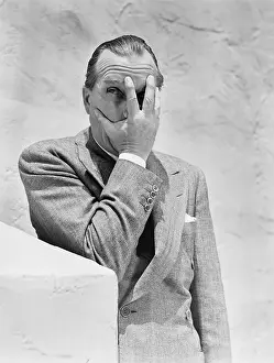 Illusions: Man putting his hand in front of his face and peeking