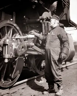 Oiling: Man Railroad Worker Engineer Wearing Overalls