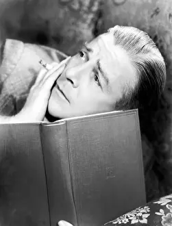 Aloneness: Man reading a book with a cigarette in a hand