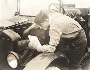 Jalopy: Man reading instructions on how to fix car