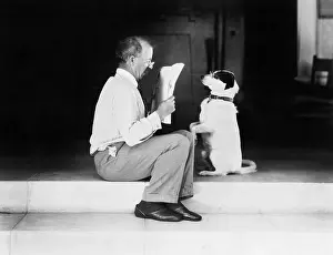 Obey: Man reading a newspaper with his dog