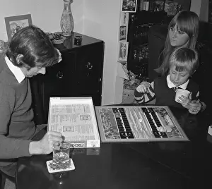 Man reading the rules of the board game Frogger