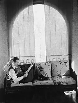 Reclined: Man reading on the sofa