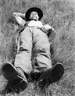 Lightheartedness: Man relaxing in meadow