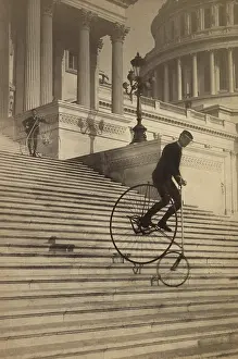 Braking: Man riding a penny-farthing bicycle down the