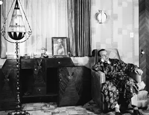 Wistful: Man in a robe sitting on a chair