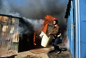 Squatter: A man runs outside clutching an armful of possessions