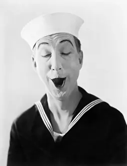 Absurdity: Man in sailor hat and uniform making a silly pantomime face